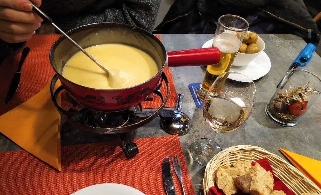 cheapest ways to travel Switzerland on a budget Swiss fondue